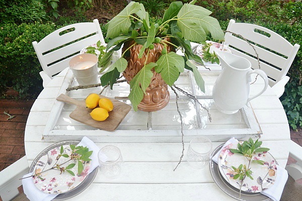 Summer patio table with a window table runner & DIY outdoor chandelier. 61833.showitstaging.com