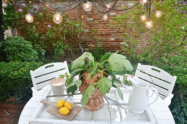 Summer patio table with a window table runner & DIY outdoor chandelier. 61833.showitstaging.com