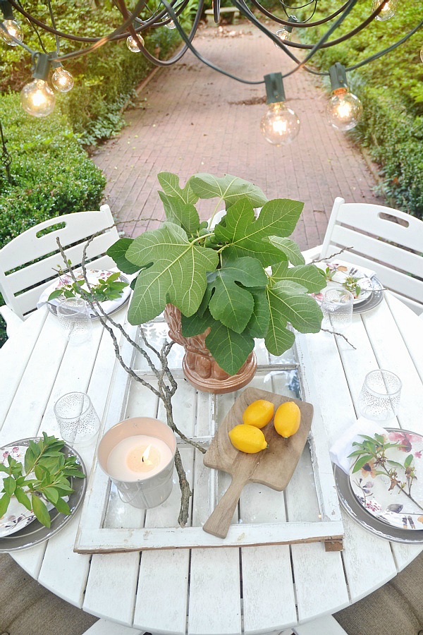 Summer patio table with a window table runner & DIY outdoor chandelier. 61833.showitstaging.com