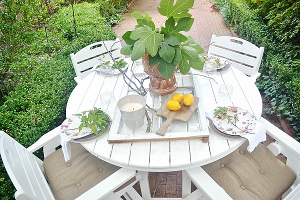 Summer patio table with a window table runner & DIY outdoor chandelier. 61833.showitstaging.com