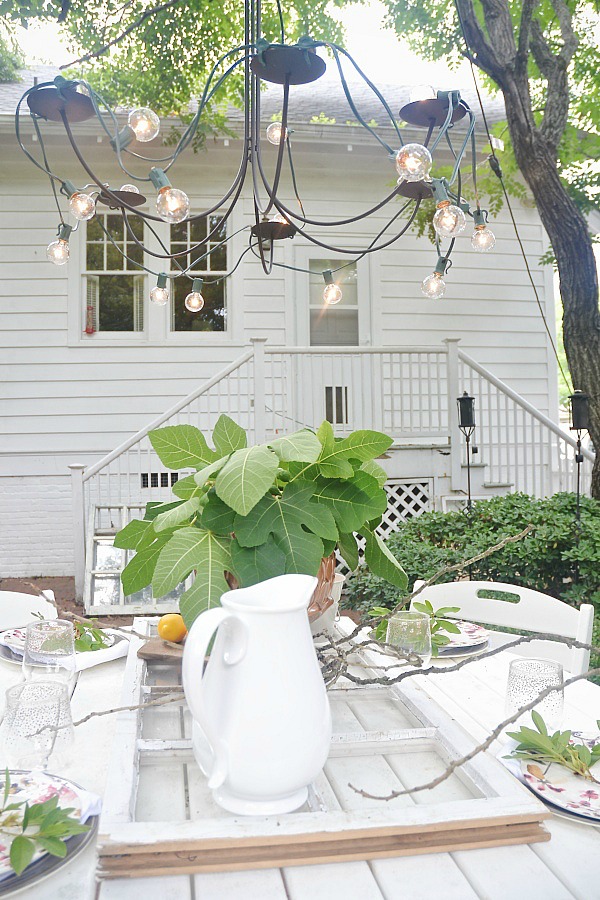 Summer patio table with a window table runner & DIY outdoor chandelier. 61833.showitstaging.com