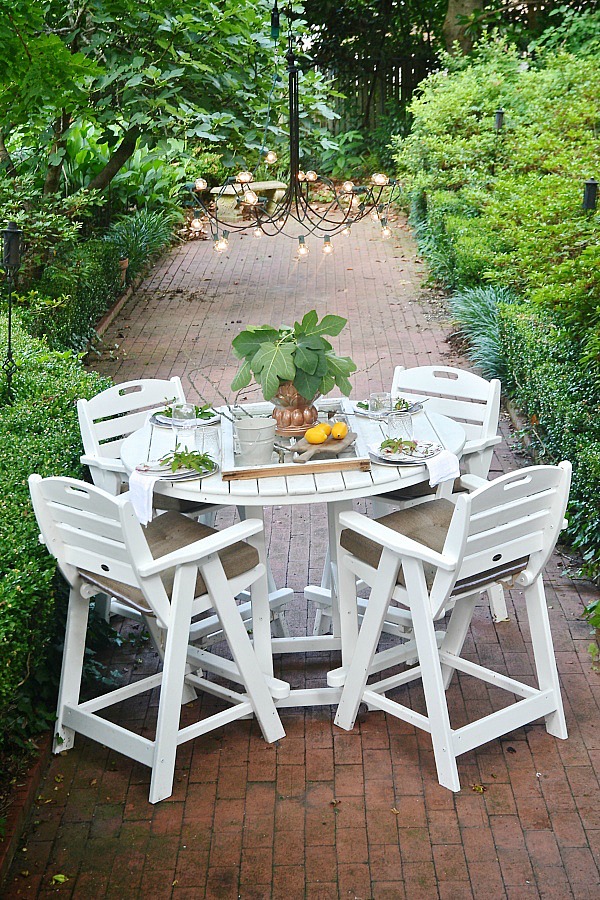 Summer patio table with a window table runner & DIY outdoor chandelier. 61833.showitstaging.com