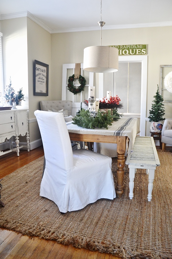 Cozy Rustic Christmas Dining Room - Christmas centerpiece, DIY wreaths, candles, texture, & more. A must pin for Christmas dining room inspiration!