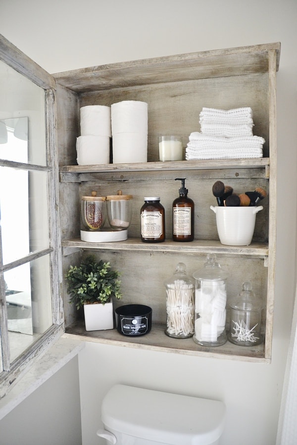 DIY antique window cabinet- See how to make this super easy antique window cabinet. Great for bathroom storage or any room in your home!