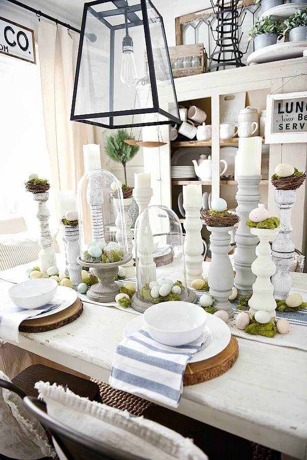 Simple Easter Dining room tablescape - rustic cottage easter decor with handmade candle holders, eggs, moss, & other touches. A must pin for Easter decor!