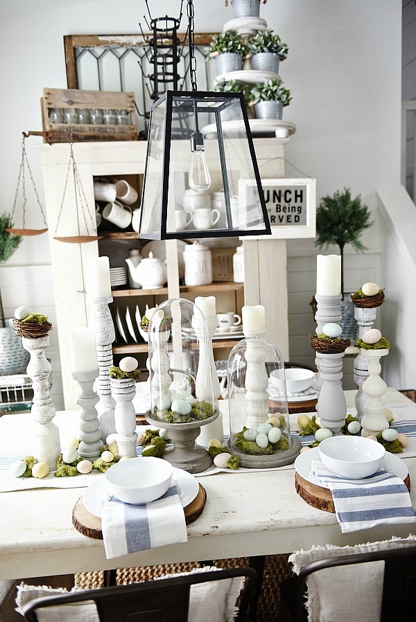 Simple Easter Dining room tablescape - rustic cottage easter decor with handmade candle holders, eggs, moss, & other touches. A must pin for Easter decor!