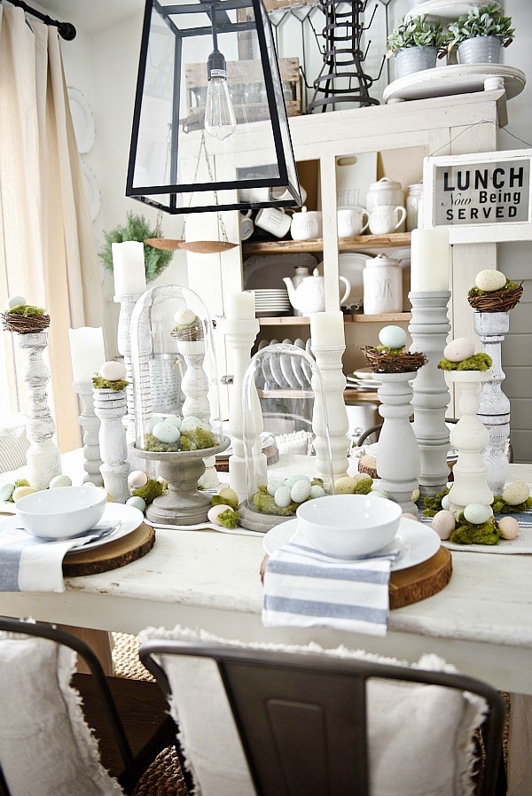 Simple Easter Dining room tablescape - rustic cottage easter decor with handmade candle holders, eggs, moss, & other touches. A must pin for Easter decor!