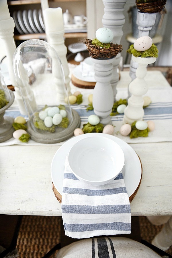 Simple Easter Dining room tablescape - rustic cottage easter decor with handmade candle holders, eggs, moss, & other touches. A must pin for Easter decor!