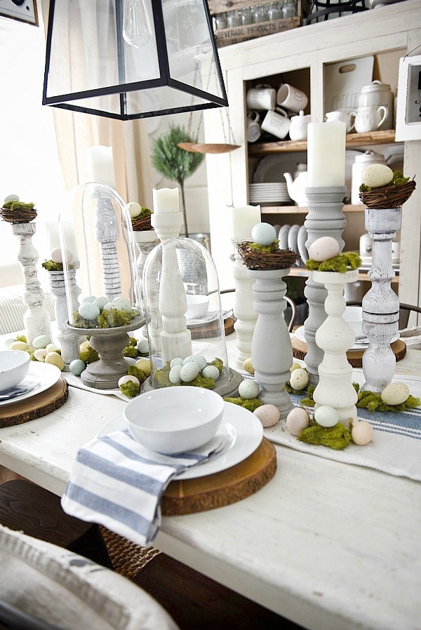 Simple Easter Dining room tablescape - rustic cottage easter decor with handmade candle holders, eggs, moss, & other touches. A must pin for Easter decor!