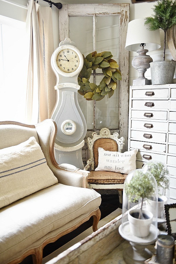 Cozy rustic cottage living room - Great pin for rustic farmhouse & cottage style decorating. A light and bright cozy living room with vintage touches like a settee, mora clock, card catalog, & so much more!