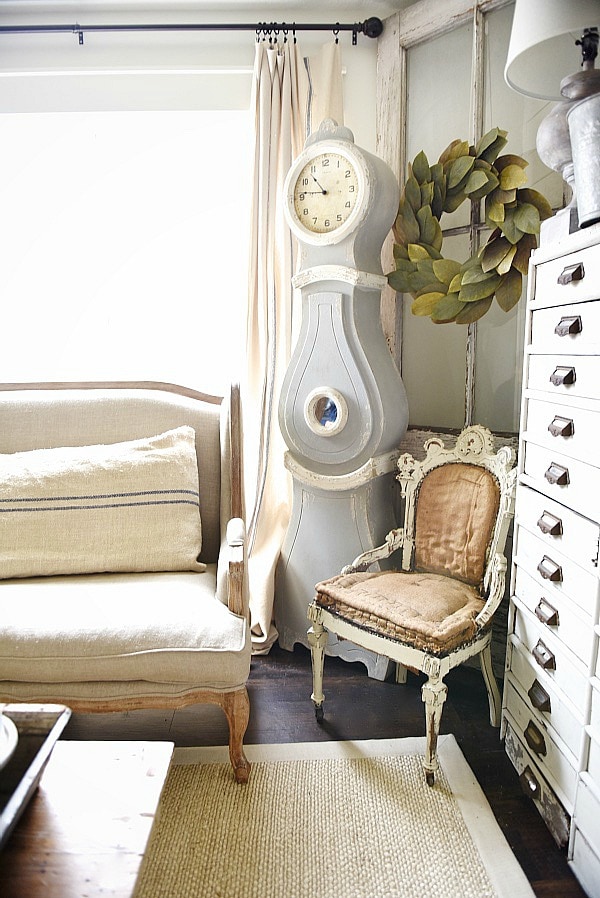 Cozy rustic cottage living room - Great pin for rustic farmhouse & cottage style decorating. A light and bright cozy living room with vintage touches like a settee, mora clock, card catalog, & so much more!