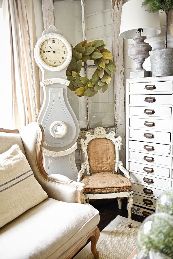 Cozy rustic cottage living room - Great pin for rustic farmhouse & cottage style decorating. A light and bright cozy living room with vintage touches like a settee, mora clock, card catalog, & so much more!
