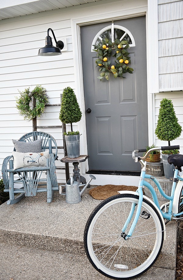 Lovely simple spring & summer porch. A great farmhouse style & cottage style front porch decor using found & new items. Pops of faux greenery so it's low maintenance too!