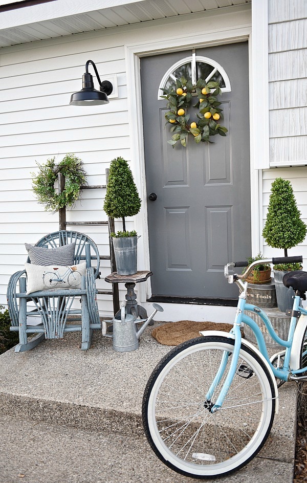 Lovely simple spring & summer porch. A great farmhouse style & cottage style front porch decor using found & new items. Pops of faux greenery so it's low maintenance too!
