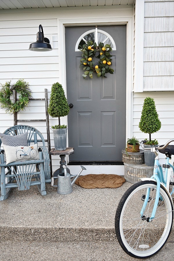Lovely simple spring & summer porch. A great farmhouse style & cottage style front porch decor using found & new items. Pops of faux greenery so it's low maintenance too!