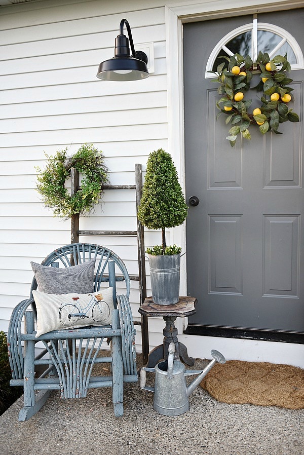 Lovely simple spring & summer porch. A great farmhouse style & cottage style front porch decor using found & new items. Pops of faux greenery so it's low maintenance too!