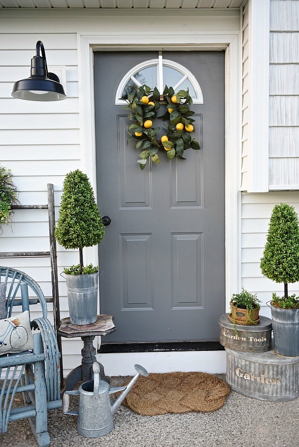 Lovely simple spring & summer porch. A great farmhouse style & cottage style front porch decor using found & new items. Pops of faux greenery so it's low maintenance too!