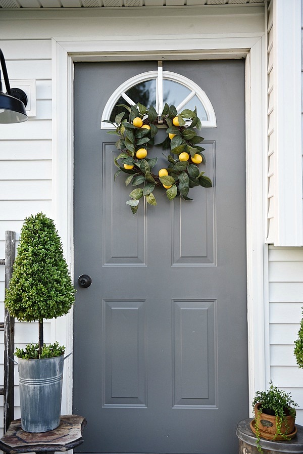 Lovely simple spring & summer porch. A great farmhouse style & cottage style front porch decor using found & new items. Pops of faux greenery so it's low maintenance too!