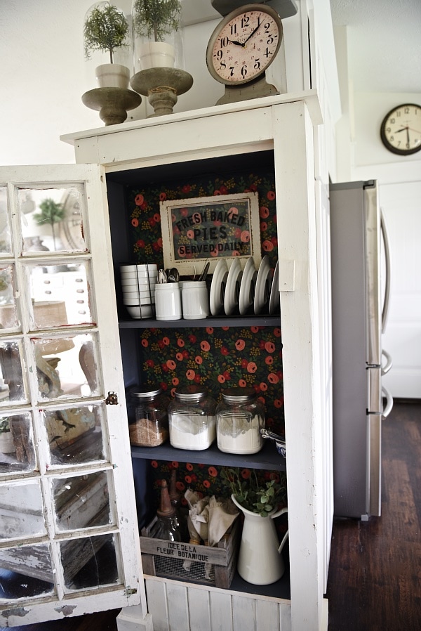 DIY Rustic window cabinet - so easy to build! This cabinet would be great in any room of the house for pretty storage. A great idea to add wrapping paper to the back of the cabinet for a pop of color. 