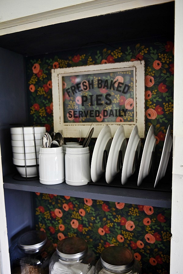 DIY Rustic window cabinet - so easy to build! This cabinet would be great in any room of the house for pretty storage. A great idea to add wrapping paper to the back of the cabinet for a pop of color. 