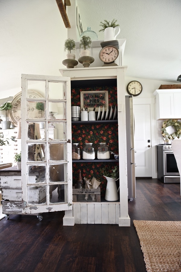 DIY Rustic window cabinet - so easy to build! This cabinet would be great in any room of the house for pretty storage. A great idea to add wrapping paper to the back of the cabinet for a pop of color. 