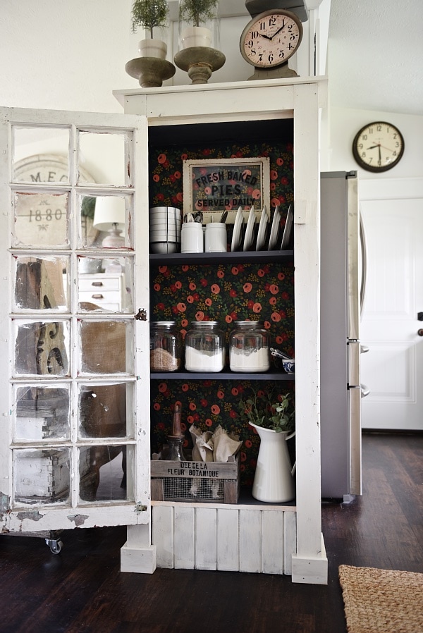 DIY Rustic window cabinet - so easy to build! This cabinet would be great in any room of the house for pretty storage. A great idea to add wrapping paper to the back of the cabinet for a pop of color. 