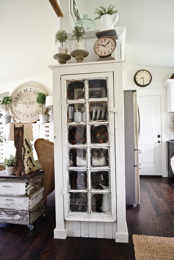 DIY Rustic window cabinet - so easy to build! This cabinet would be great in any room of the house for pretty storage. A great idea to add wrapping paper to the back of the cabinet for a pop of color. 