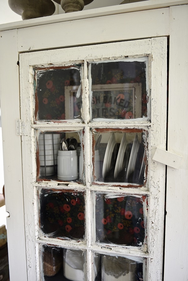 DIY Rustic window cabinet - so easy to build! This cabinet would be great in any room of the house for pretty storage. A great idea to add wrapping paper to the back of the cabinet for a pop of color. 