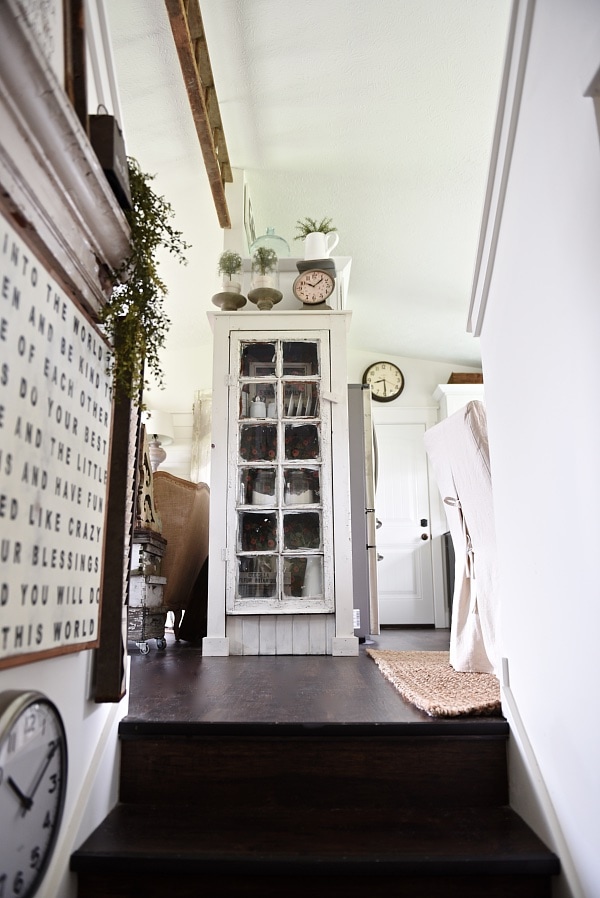 DIY Rustic window cabinet - so easy to build! This cabinet would be great in any room of the house for pretty storage. A great idea to add wrapping paper to the back of the cabinet for a pop of color. 