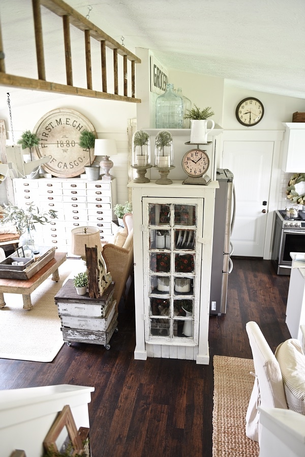 DIY Rustic window cabinet - so easy to build! This cabinet would be great in any room of the house for pretty storage. A great idea to add wrapping paper to the back of the cabinet for a pop of color. 