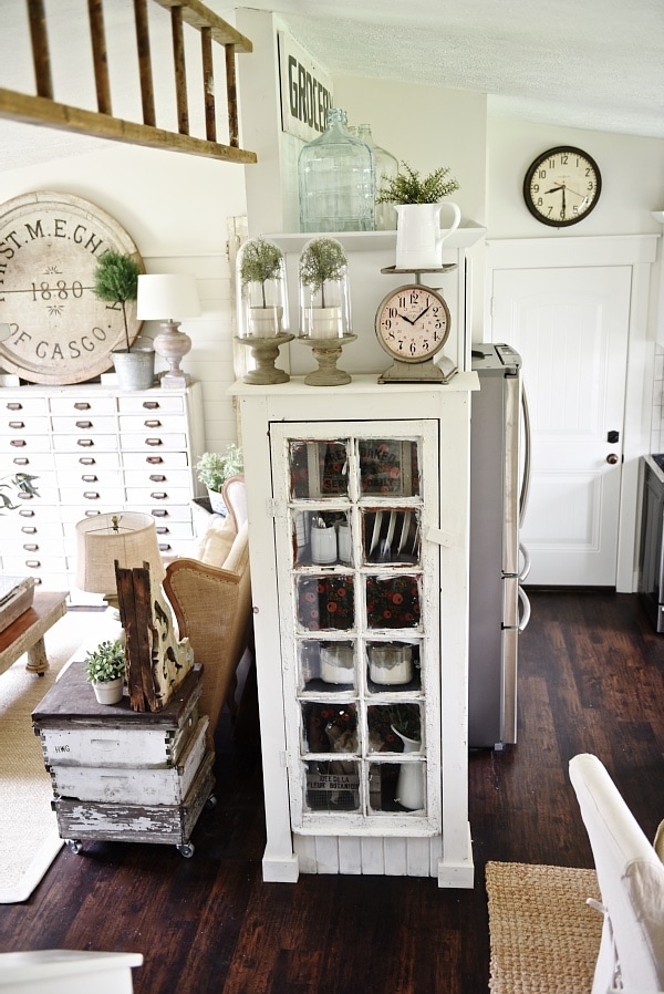 DIY Rustic window cabinet - so easy to build! This cabinet would be great in any room of the house for pretty storage. A great idea to add wrapping paper to the back of the cabinet for a pop of color. 