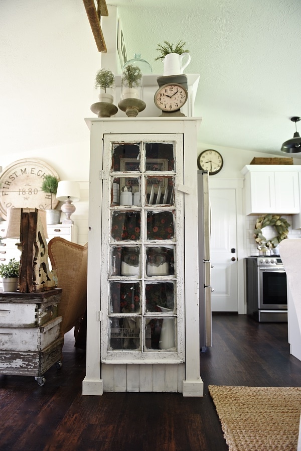 DIY Rustic window cabinet - so easy to build! This cabinet would be great in any room of the house for pretty storage. A great idea to add wrapping paper to the back of the cabinet for a pop of color. 