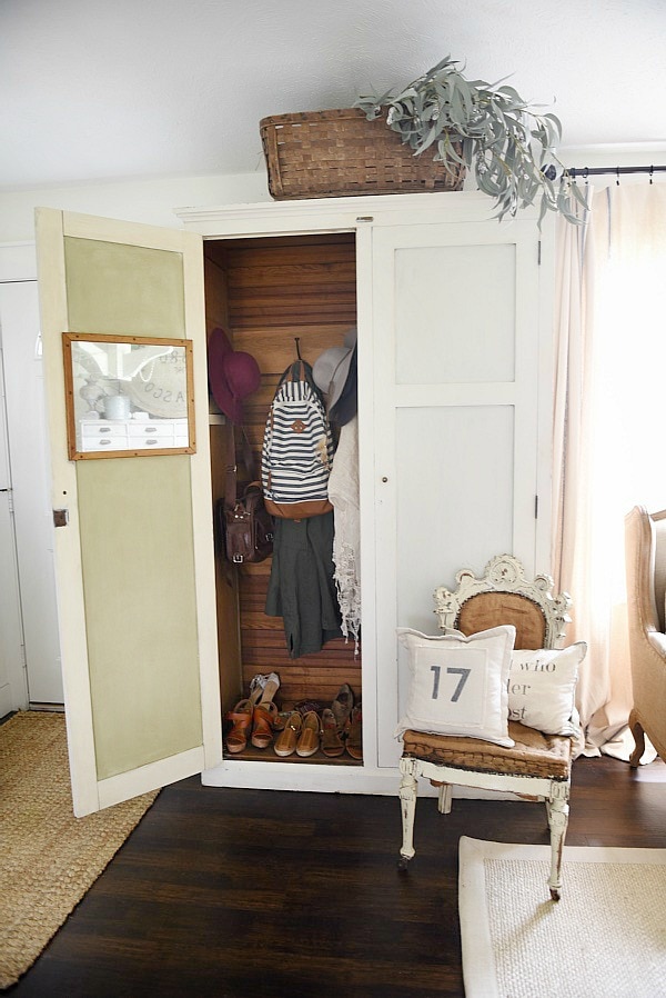 Entryway armoire - a great way to add storage to an entryway. If the closet is too small or if there isn't a closet an armoire adds amazing storage that you can hide away the mess! 