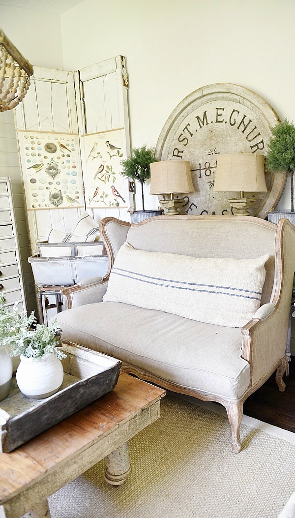 DIY Bi-fold doors in the living room to cover a wall vent. Great Farmhouse decor inspiration. & a great way to cover a wall vent!