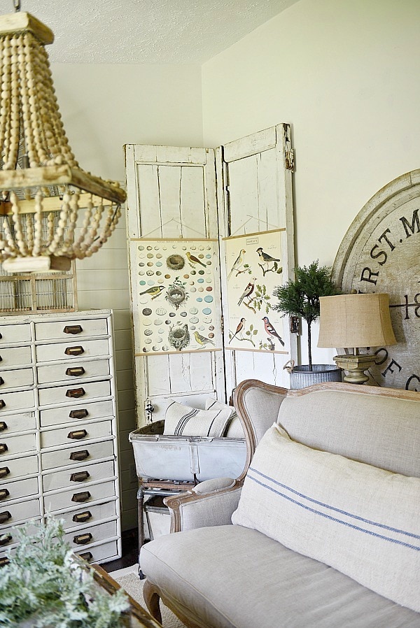 DIY Bi-fold doors in the living room to cover a wall vent. Great Farmhouse decor inspiration. & a great way to cover a wall vent!