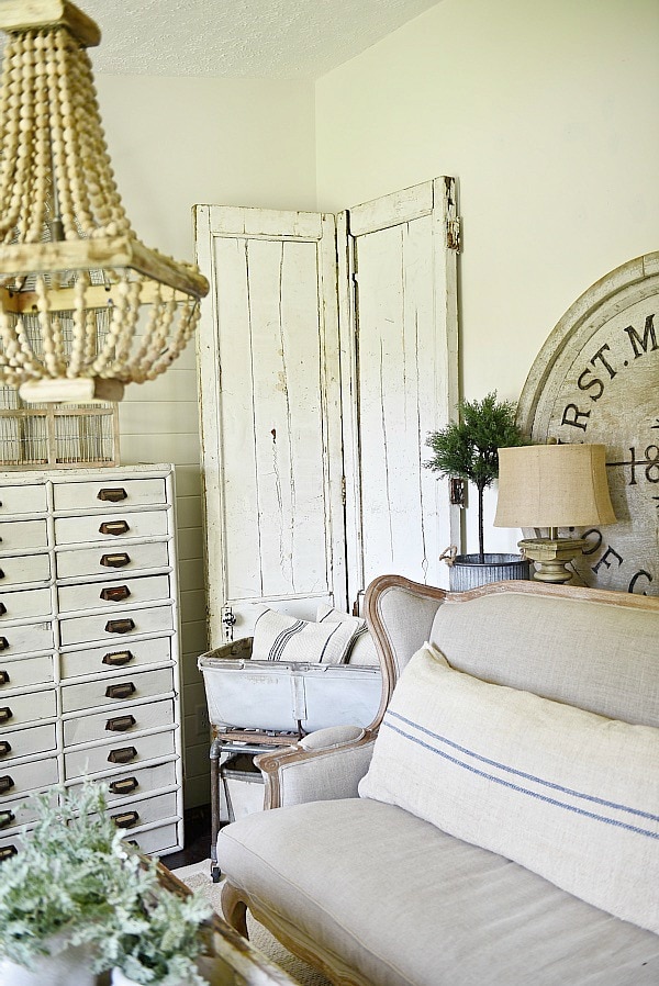 DIY Bi-fold doors in the living room to cover a wall vent. Great Farmhouse decor inspiration. & a great way to cover a wall vent!