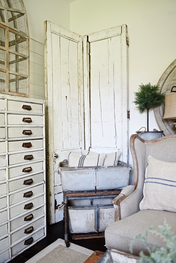 DIY Bi-fold doors in the living room to cover a wall vent. Great Farmhouse decor inspiration. & a great way to cover a wall vent!