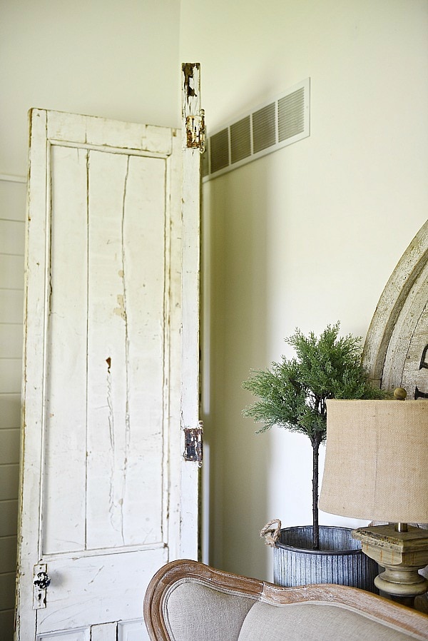 DIY Bi-fold doors in the living room to cover a wall vent. Great Farmhouse decor inspiration. & a great way to cover a wall vent!