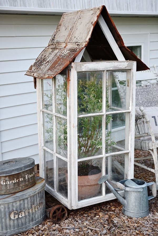 DIY window greenhouse - See how to make this amazing rustic greenhouse. A super easy DIY project that adds rustic charm indoors or outdoors. A great pin for DIY farmhouse decor! 