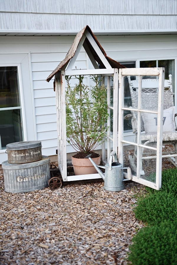 DIY window greenhouse - See how to make this amazing rustic greenhouse. A super easy DIY project that adds rustic charm indoors or outdoors. A great pin for DIY farmhouse decor! 