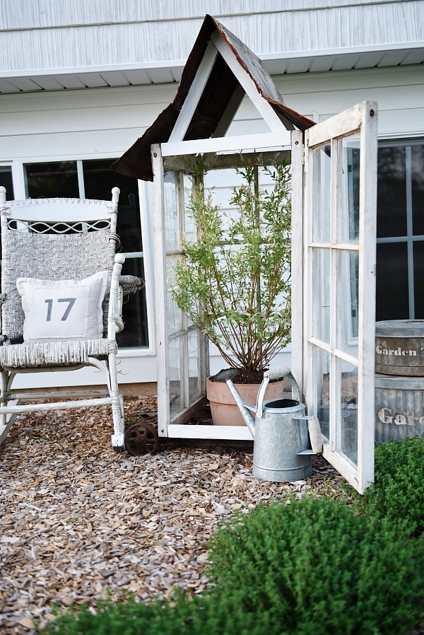 DIY window greenhouse - See how to make this amazing rustic greenhouse. A super easy DIY project that adds rustic charm indoors or outdoors. A great pin for DIY farmhouse decor! 