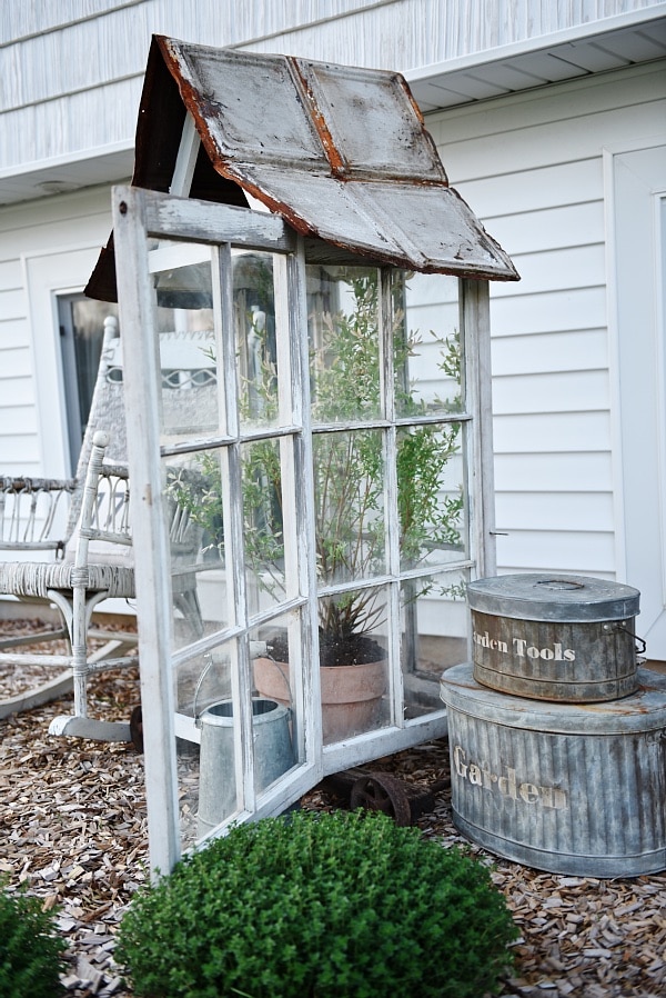 DIY window greenhouse - See how to make this amazing rustic greenhouse. A super easy DIY project that adds rustic charm indoors or outdoors. A great pin for DIY farmhouse decor! 