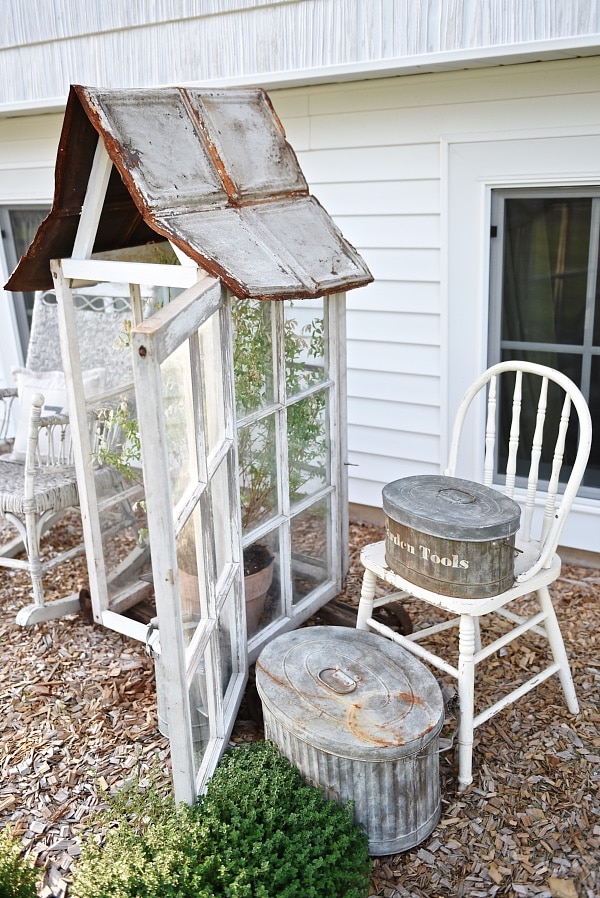 DIY window greenhouse - See how to make this amazing rustic greenhouse. A super easy DIY project that adds rustic charm indoors or outdoors. A great pin for DIY farmhouse decor! 