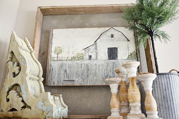 Farmhouse style vignette - A rustic barn painting in a farmhouse living room. A great pin for farmhouse decor ideas!! 