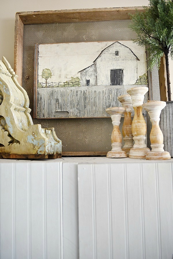 Farmhouse style vignette - A rustic barn painting in a farmhouse living room. A great pin for farmhouse decor ideas!! 