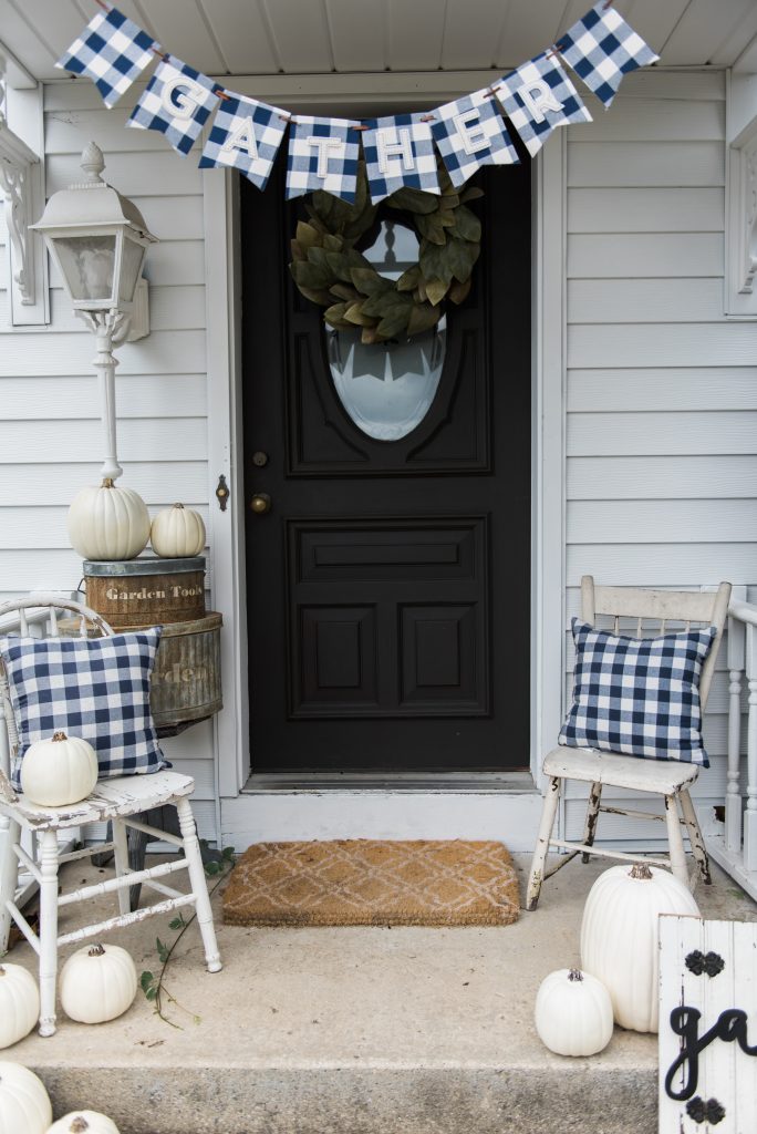 Farmhouse buffalo check fall decor on the back stoop - Great farmhouse fall decor inspiration. 