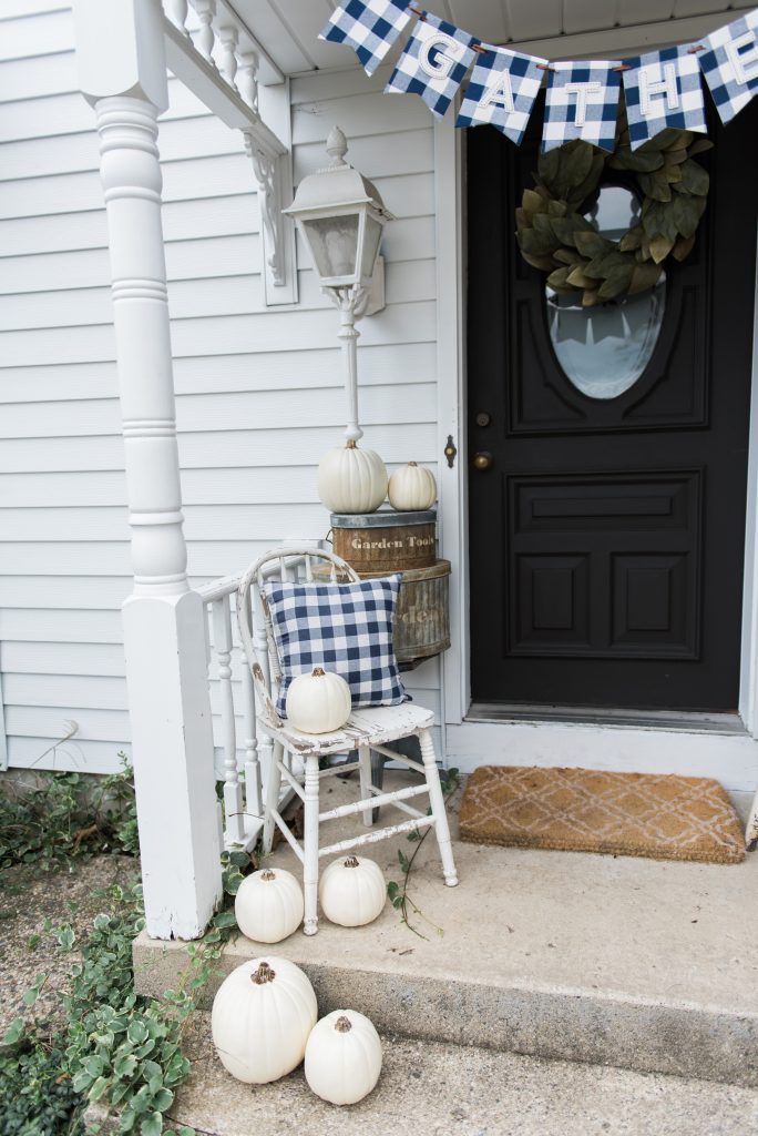Farmhouse buffalo check fall decor on the back stoop - Great farmhouse fall decor inspiration. 