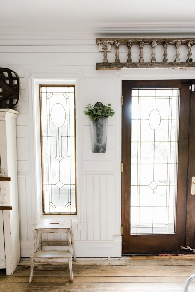 Hanging metal vases with flowers hanging on each side of the french doors. Great farmhouse decor style tips & tricks. A must pin for cottage style and farmhouse style decor. Metal flower vases from Magnolia Market 