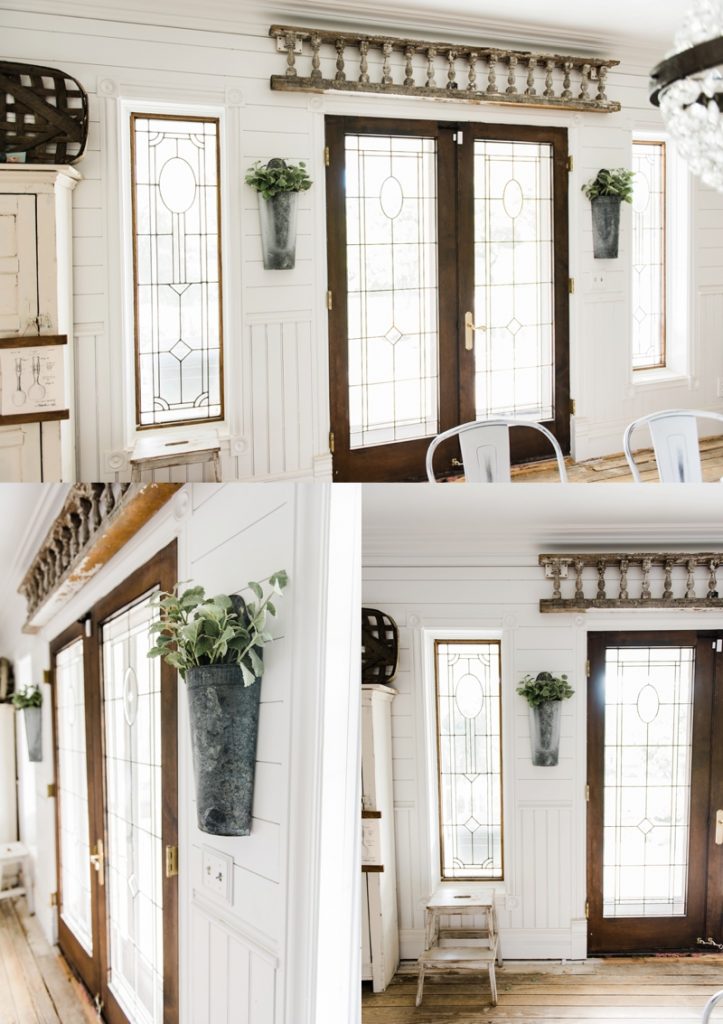 Hanging metal vases with flowers hanging on each side of the french doors. Great farmhouse decor style tips & tricks. A must pin for cottage style and farmhouse style decor. Metal flower vases from Magnolia Market 