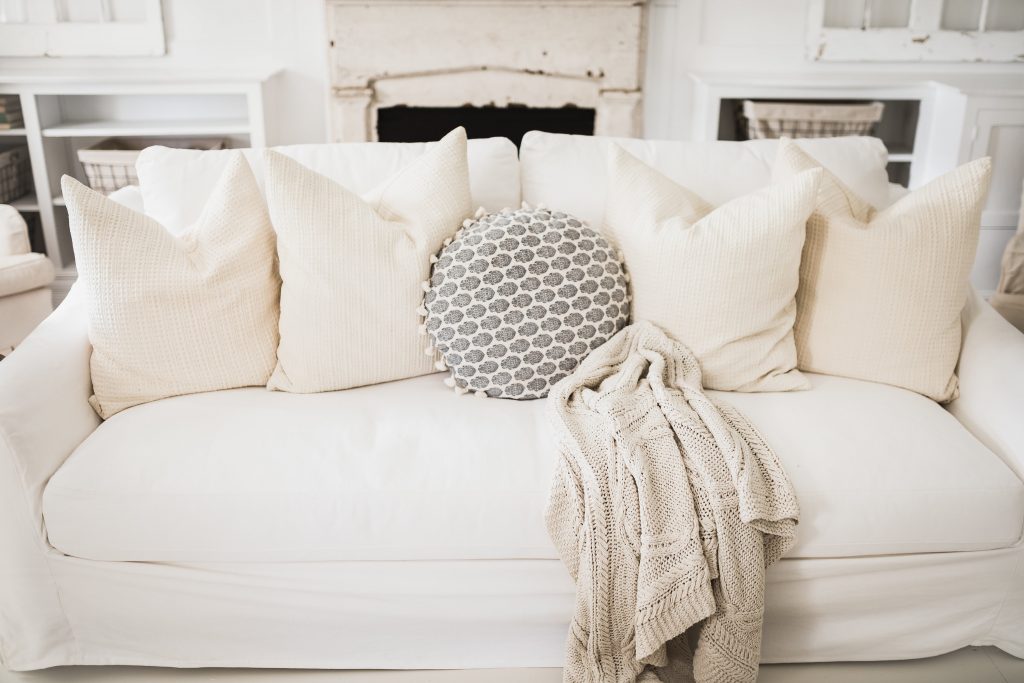 an Ikea sofa with Bemz slipcover on it in a cottage style setting